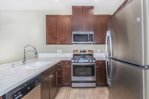 a kitchen with stainless steel appliances and wooden cabinets