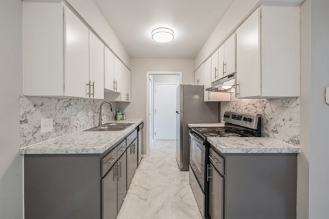 a kitchen with stainless steel appliances and marble counter tops