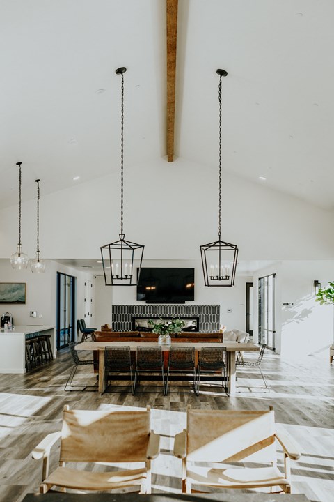 a dining room with a table and chairs and a living room