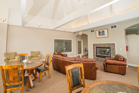 a living room with a couch and a table and chairs