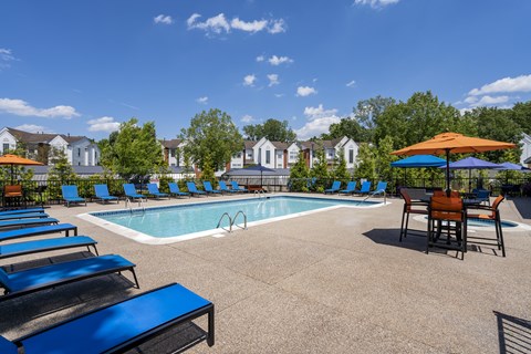 our apartments have a resort style pool with chairs and umbrellas