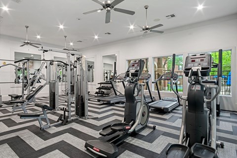 the residence apartments gym with weights and cardio equipment