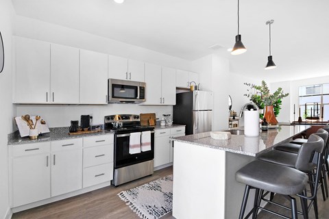 a kitchen with white cabinets and a counter top