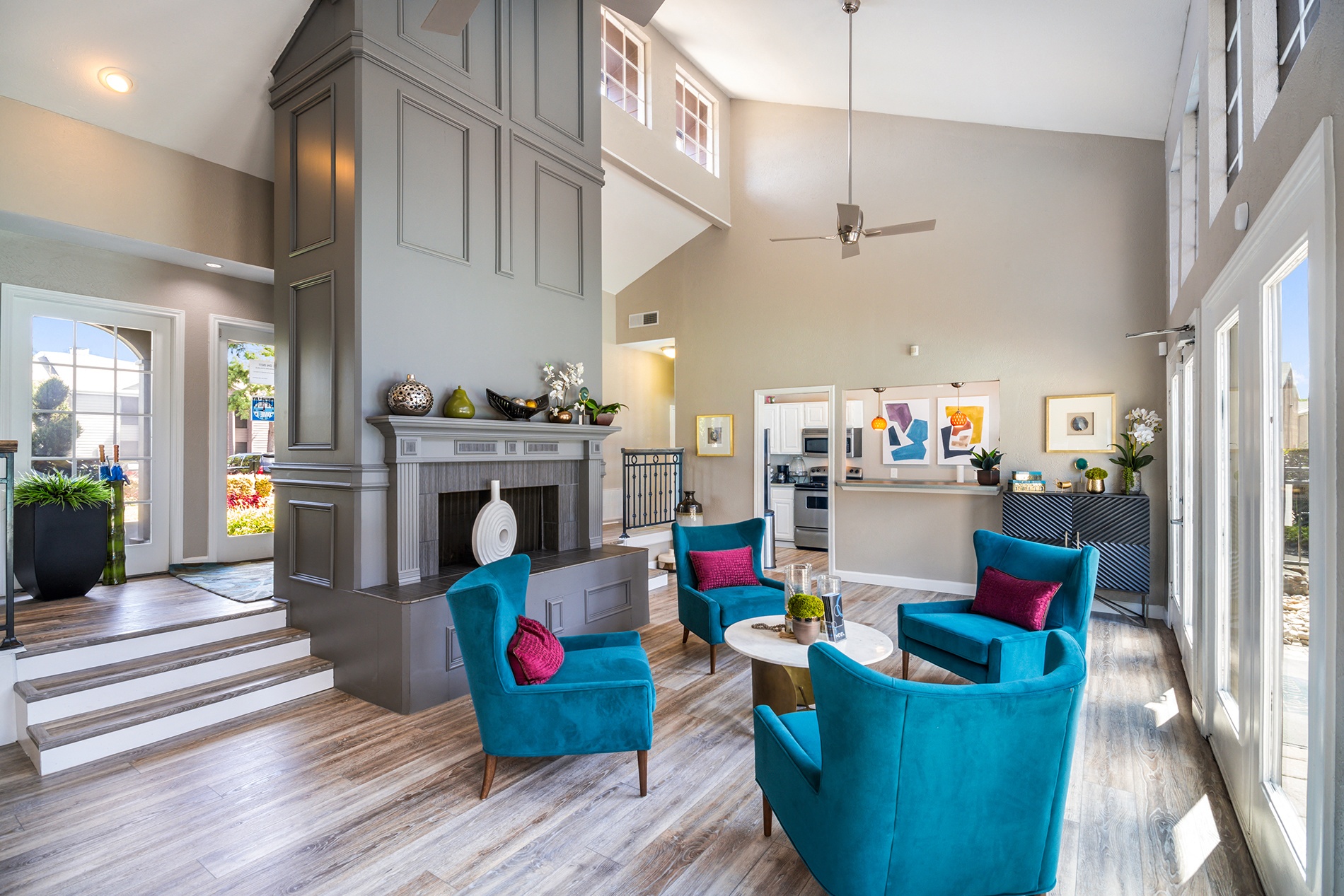 a living room with blue chairs and a fireplace