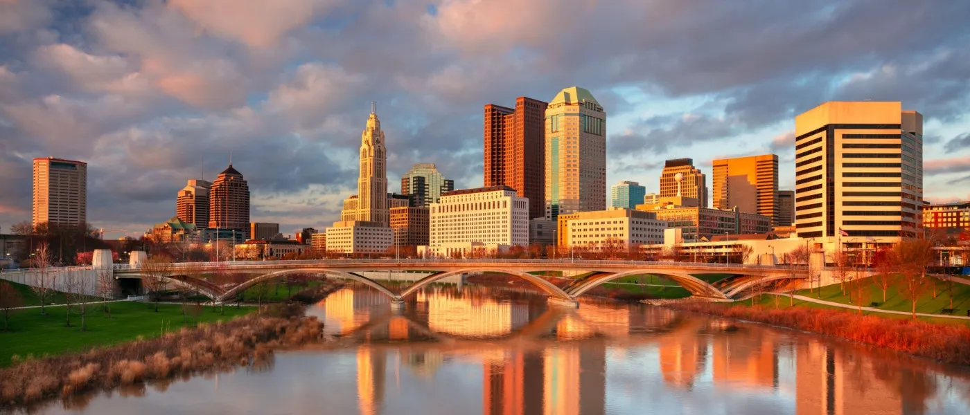 Columbus, Ohio skyline with the reflection of the city in the Scioto River at spring sunset.