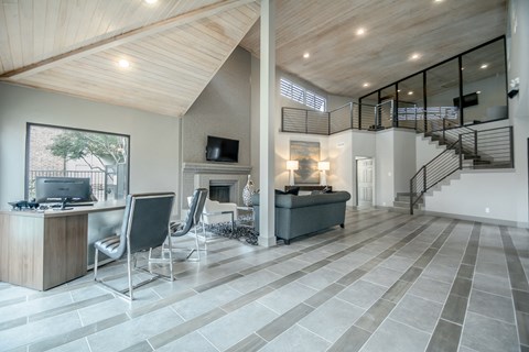 a living room with a fireplace and a table and chairs