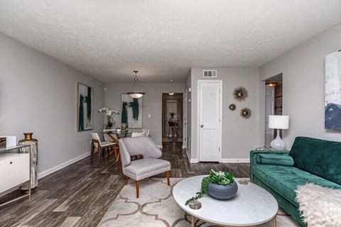 a living room with a green couch and a table