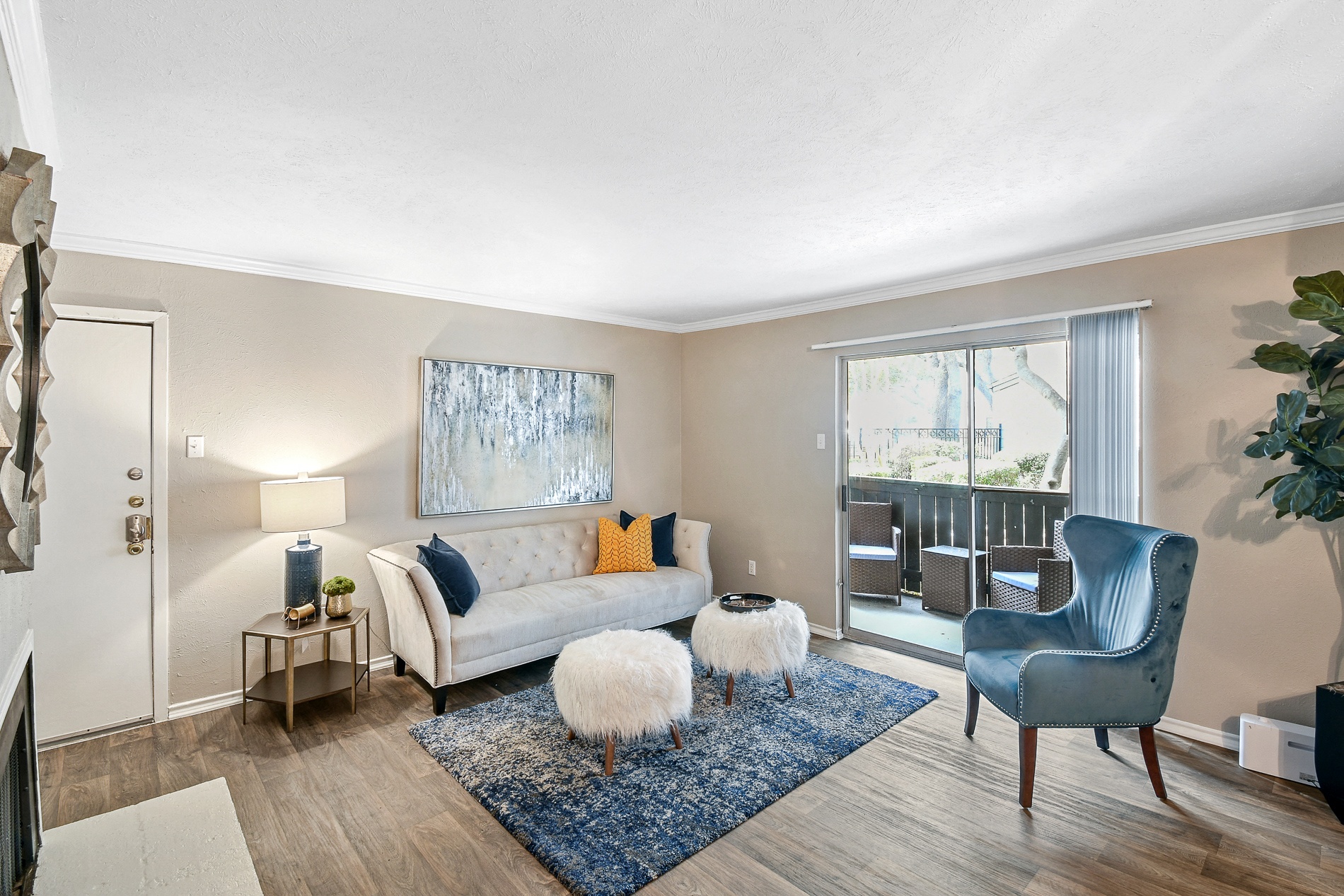 a living room with a couch and a chair and a window