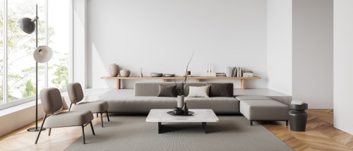 interior of an apartment with a sofa, armchairs and a coffee table