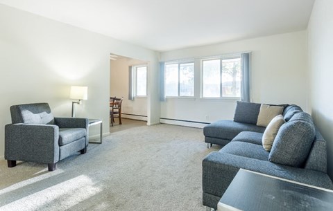 a living room with couches and chairs and a table