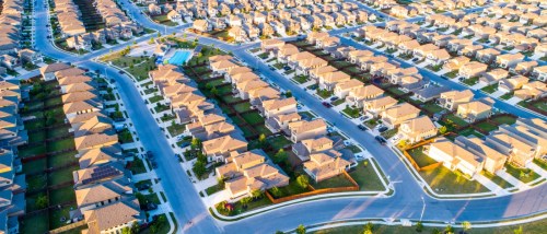 suburban housing neighborhood homes in suburbia - aerial drone view - above Austin, Texas, USA perfect cubed square houses living area in real estate suburban community at sunset summer