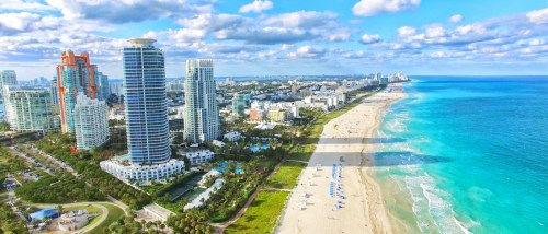 view of miami beach with apartment buildings and shore