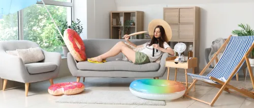 Young woman with fan ready for a summer staycation.