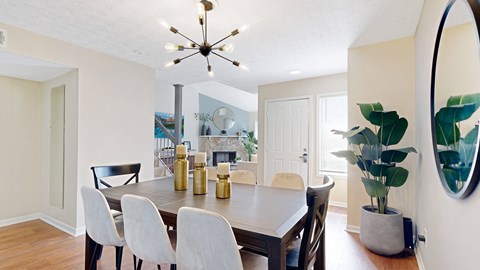 a dining room with a table and chairs and a chandelier