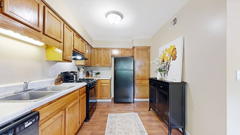 a kitchen with wooden cabinets and black appliances