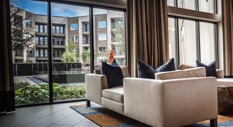 a living room with a couch and large windows