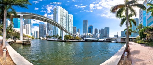 Miami downtown skyline and futuristic mover train above Miami river panoramic view, Florida state, USA.