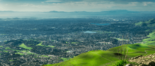 view of silicon valley buildings and landscape from atop mission peak hill