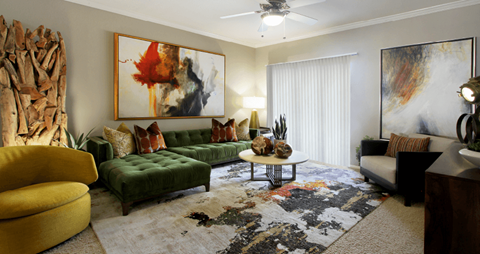 a living room with a green couch and a rug