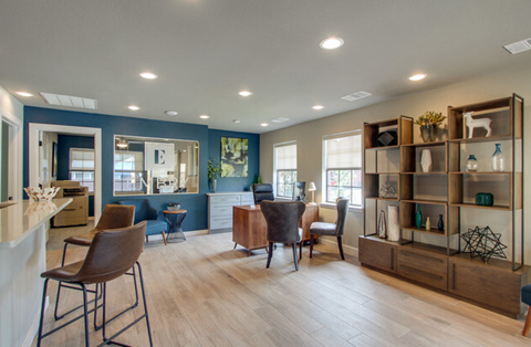 a living room with a table and chairs and a kitchen